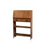 A 1920s stripped light oak student's bureau, the upright fall enclosing a fitted interior, over a