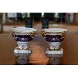 A pair of early 19th century Derby porcelain pot pourris, decorated in cobalt blue and gilt with