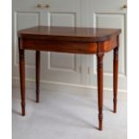 An early 19th century mahogany D-shaped tea table, the foldover top with reeded edge, raised on