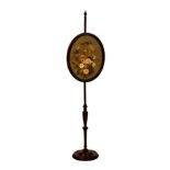A mid-19th century turned mahogany pole screen, with turned circular base and oval glazed screen,
