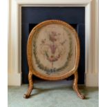 A 19th century oval giltwood firescreen, the foliate and egg & dart decorated frame raised on