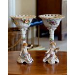 A pair of Sitzendorf style porcelain comports, German, 20th century, the reticulated dished bowls on