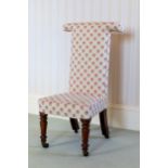 A Victorian rosewood prie-dieu chair, the T-shaped back and seat well upholstered in floral sprigged