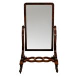 A Victorian mahogany cheval mirror, the rectangular plate with rounded top angles, raised on