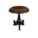 An Anglo-Indian carved hardwood centre table, c.1900, the circular top with foliate carved border