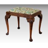 A George II style walnut stool, circa 1900, the drop in pale green ground floral petit point seat