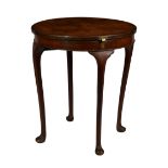 A 1930s quarter veneered figured walnut circular card table, the top hinged and swivelling to reveal
