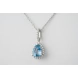 An 18ct pear aquamarine and diamond pendant, the 0.86ct pear cut aquamarine surrounded by a halo