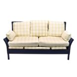 A blue painted wicker conservatory settee, with cream and buff chequered loose cushions, 72in. (