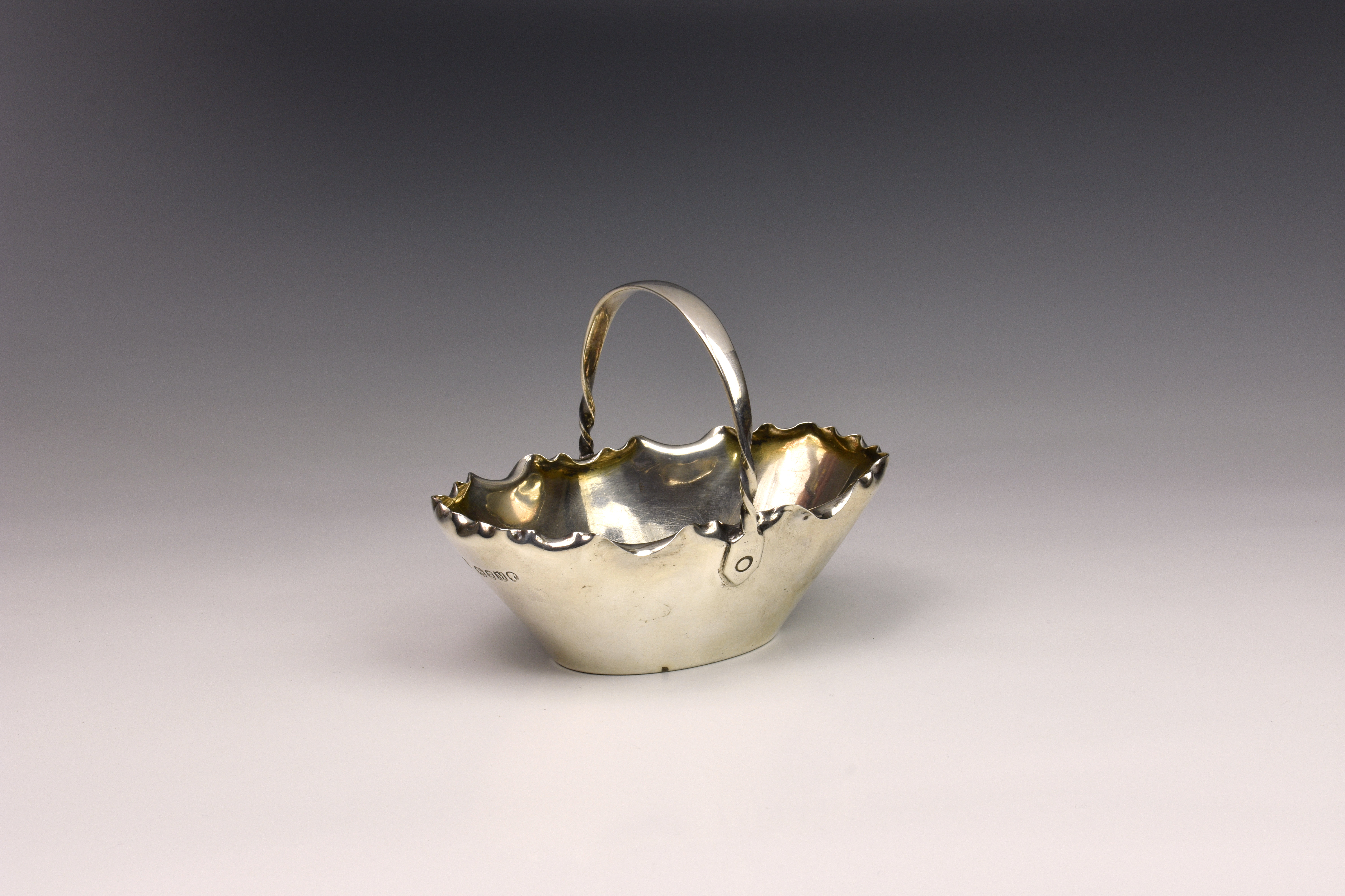 A Victorian silver sugar basket, Hukin & Heath, London 1887, of typical oval form with crimped rim