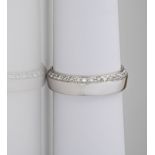 An 18ct white gold diamond set band, of contemporary design with a row of pavé diamonds set to the