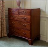 A George III mahogany straight front chest, the rectangular top over two short and three long