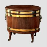A George III oval brass banded mahogany wine cooler, the moulded top with brass handle enclosing a