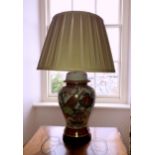An Oriental style porcelain vase lamp, with pleated silk shade, 24½in. (62.2cm.) high.