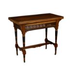 A Victorian Aesthetic Movement walnut, ebonised and parcel gilt fold over card table, the