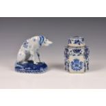 A Dutch Delft blue & white figure of a seated dog, probably 19th century, with floral decoration