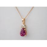 An 18ct rose gold, pink sapphire and diamond pendant on an 18ct rose gold chain, the pear cut pink