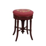 A Victorian painted adjustable piano stool, the circular petit point seat on a gadroon and rosette