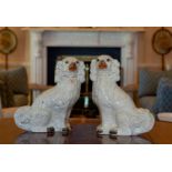 A pair of Victorian white glazed Staffordshire dogs, 12in. (30.5cm.) high. (2)
