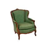 A Louis XVI style carved beechwood and parcel gilt wingback fauteuil, early 20th century, the