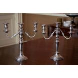 A pair of good quality twin branch silver plated table candelabra, with tapering knopped columns,