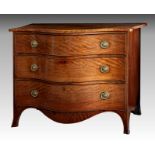 A George III Hepplewhite serpentine mahogany commode, the boxwood strung top over three long