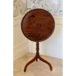 A 19th century mahogany tilt-top tripod table, the dished circular top on a turned column and