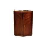 A late 18th century mahogany peaked front corner cupboard, the two well figured doors enclosing