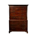 A George III mahogany chest on chest, the dentil cornice over a blind fret frieze, the top with