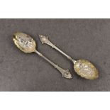A pair of Victorian silver berry spoons, Elkington & Co., Birmingham 1873, each with shaped terminal