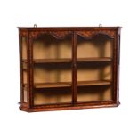 An early 19th century walnut and Dutch marquetry glazed hanging cabinet, the cavetto moulded top