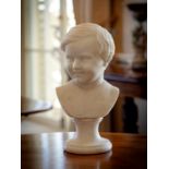 A Victorian carved marble bust of a boy, third quarter 19th century, with combed hair, the smiling