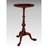 A George III style mahogany tripod wine table, circa 1900, the circular piecrust top on a turned and