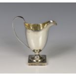 A George III silver helmet cream jug, maker's mark indistinct, London 1801, of typical form with