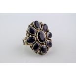 A garnet and silver gilt ring, probably Indian in origin and featuring 8 oval cut garnets around a