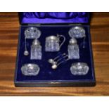 An Edwardian cased cut crystal and silver condiment set, J. C. Plimton & Co., Birmingham 1907,