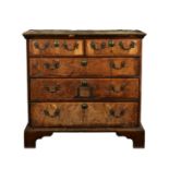 Irish (Butler family) interest - A George I walnut chest of drawers, the ogee moulded cross banded