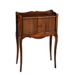 A late 19th century French tambour front bedside cabinet, the three quarter tray top over a