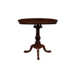 A George III mahogany tripod table with birdcage mechanism, the circular top revolving on a birdcage