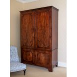 A George III mahogany linen press, the cavetto cornice over a pair of fielded panelled doors with