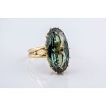 An 9ct yellow gold and Tourmaline cocktail ring, the elongated oval cut tourmaline measuring