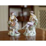 A pair of Sitzendorf porcelain figures, 20th century, depicting a gentleman flute player with a
