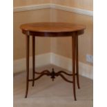 An Edwardian mahogany oval occasional table, the boxwood inlaid top raised on square tapered legs