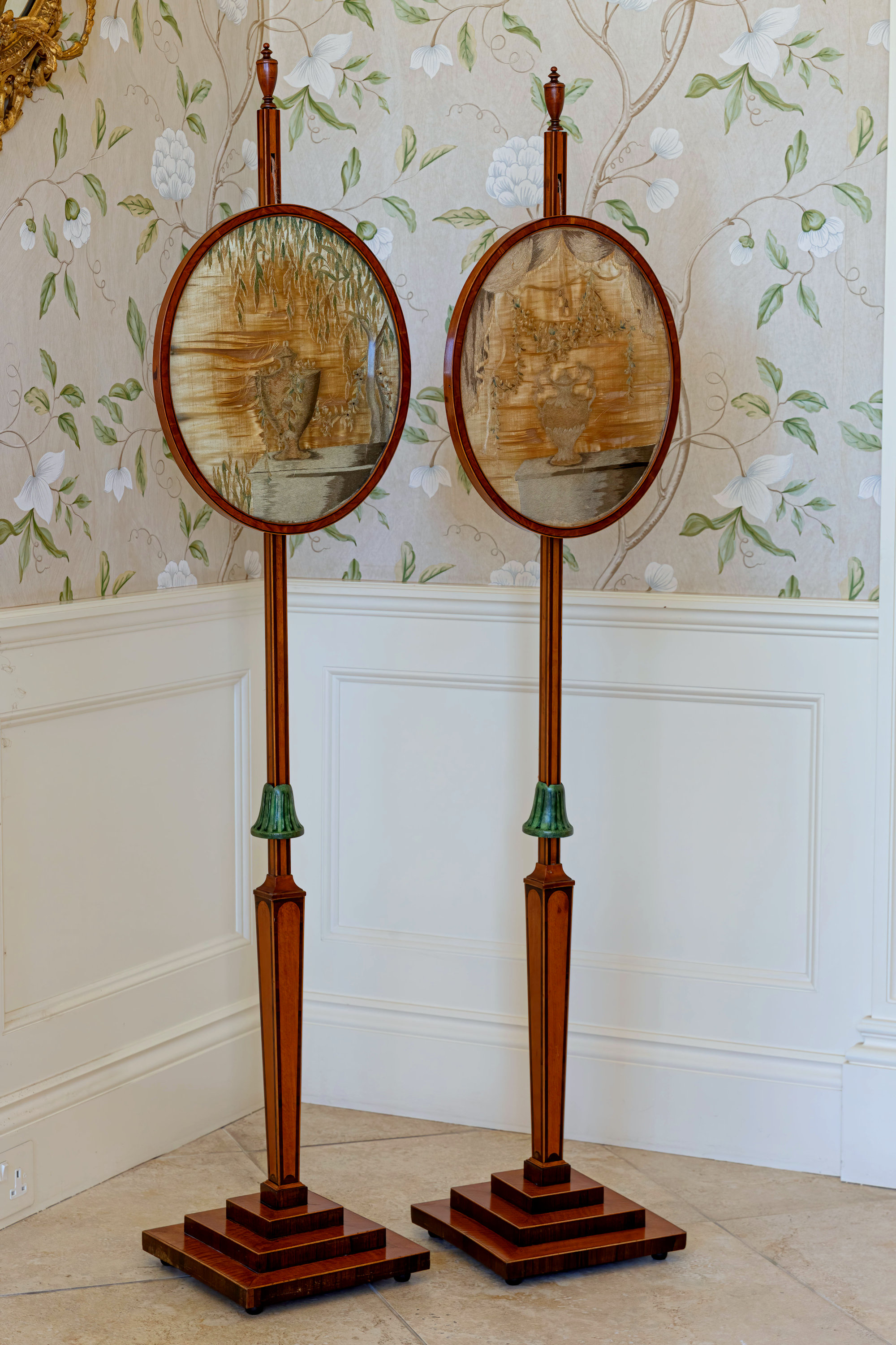 A good pair of Regency satinwood and rosewood pole screens, the square section rosewood banded