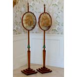 A good pair of Regency satinwood and rosewood pole screens, the square section rosewood banded