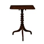 A mid-19th century mahogany tilt-top tripod table, the rectangular top on a turned column and