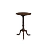 An early 19th century mahogany tilt-top tripod table, the circular dished top on a turned baluster