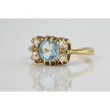 A mid-century 18ct yellow gold, aquamarine and diamond ring, the central cushion cut aquamarine