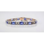 An Art Deco style white gold, sapphire and diamond bracelet, the pierced box links with bright cut