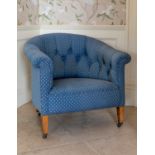A 19th century tub back armchair, the buttoned back, scrolled arms and seat in blue and gold